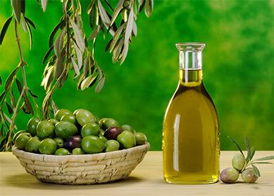 Olivenöl in einer Flasche und einem Teller mit Oliven