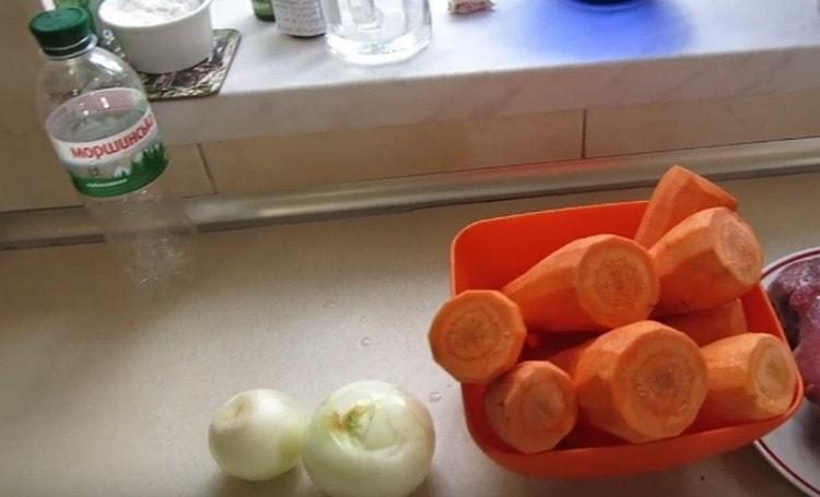 Zwiebeln und Karotten schälen und hacken.