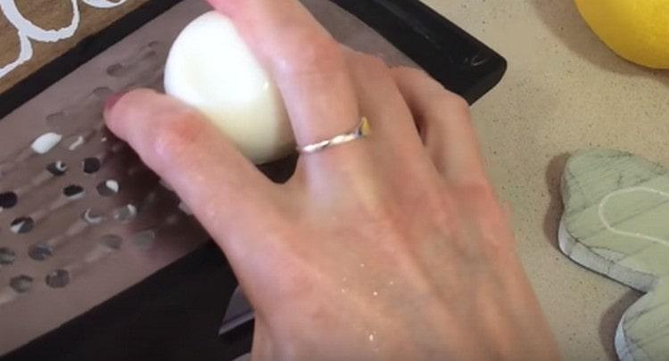 Drei gekochte Eier auf einer Reibe.