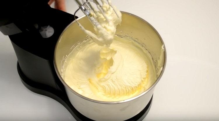 Upang ihanda ang cream, talunin ang pinalambot na mantikilya na may kondensadong gatas.